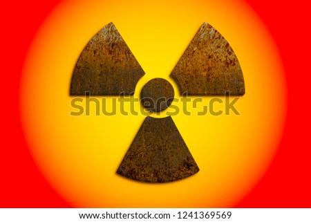 Radioactive (ionizing radiation) nuclear danger symbol constructed of 3D rusty metal grungy texture and isolated on yellow and red danger alert colors circular background. 