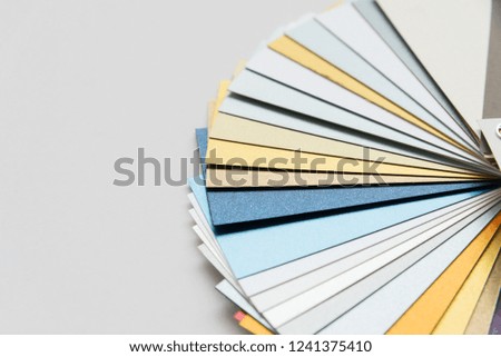 Layout of color paper samples of metallic shades on white background in focus and out of focus