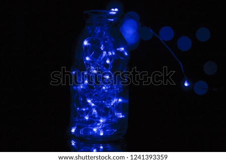 Glass jar with light bulbs and decorative Christmas decoration.