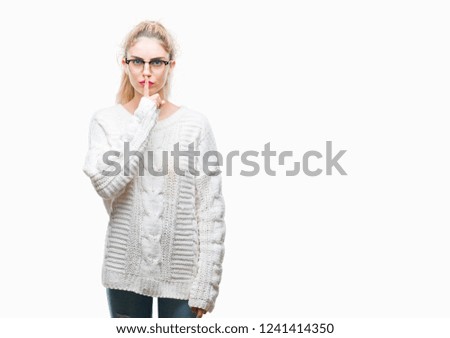 Young beautiful blonde woman wearing glasses over isolated background asking to be quiet with finger on lips. Silence and secret concept.