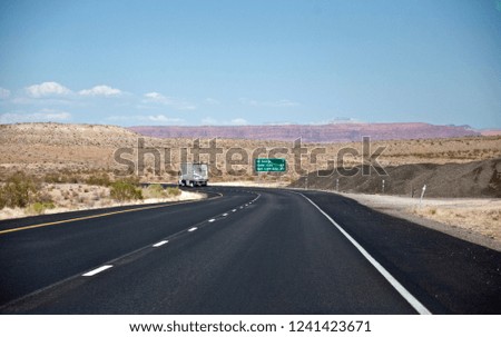 Road with truck in desert in USA