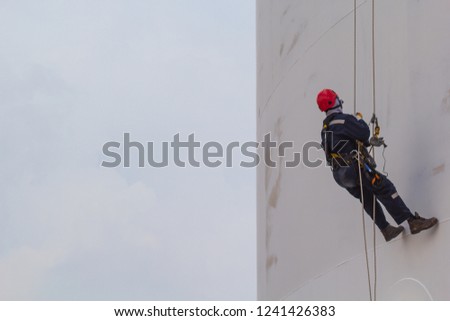Male worker rope access  inspection of thickness shell plate storage tank industry