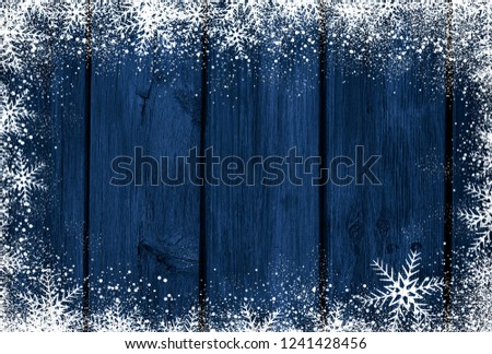 Blue wooden Christmas background with snowflakes