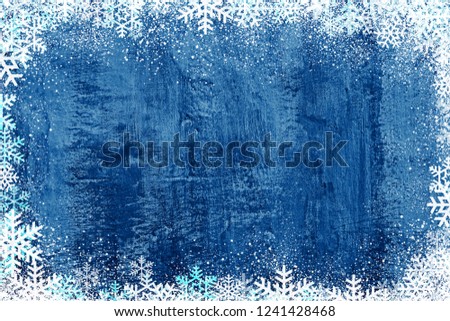 Blue wall Christmas winter background with snowflakes