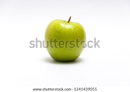 Green tasty apple on the white