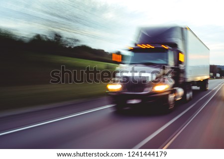 Semi truck on highway concept with motion blur	 Royalty-Free Stock Photo #1241444179