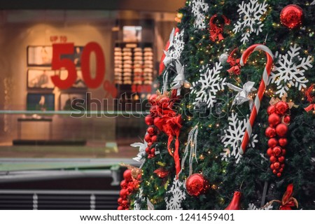 Christmas Pic. Decorated Christmas tree on blurred, 50% sale. Sale season background. Christmas tree close up.