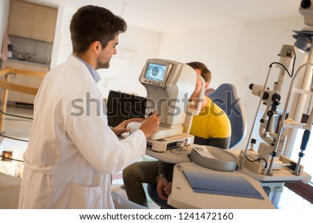 Men having an eye exam at ophthalmologist's office