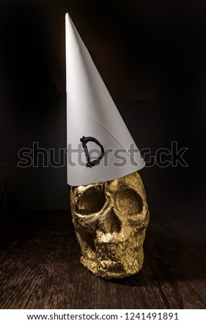 Gold skull fool made from fools gold wearing dunce cap