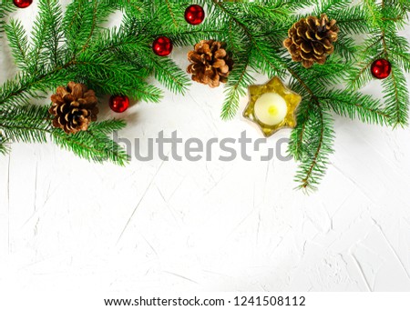 Christmas holiday background with fir branches, pine cones and ornaments. Winter holiday concept composition, copy space