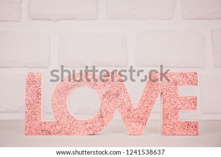 Red sign LOVE. Valentine day concept. Trendy minimalistic holiday design background. Soft focus. Horizontal, surreal toned image
