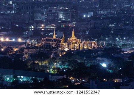 aerial view of temple of emerald Buddha and the grand palace of Thailand. historical landmark in dense urban skyline. night view of the city.