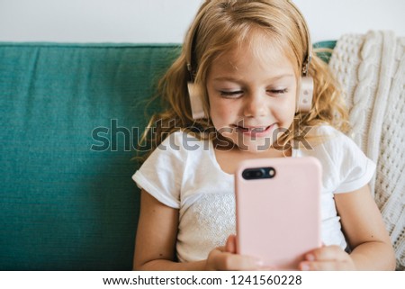 Little girl watching cartoons on her phone