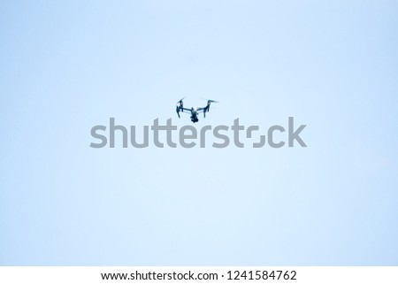 flying drone on blue sky background