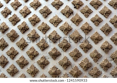 Clay carving with traditional Thai flower pattern