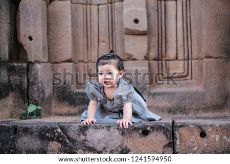 Asian children  are sitting at Prasat Wat Sa Kamphaeng Yai, Sisaket Province, Thailand, Asia
