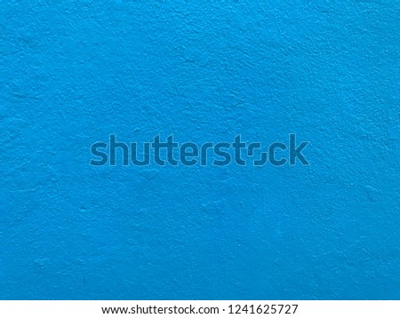 Blue color painted on concrete wall texture background 