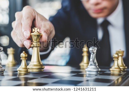 Businessman playing chess game reaching to plan strategy for success, thinking for planning overcoming difficulty and achieving goals business strategy for win, management or leadership concept.