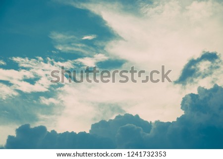 Turquoise blue and white cumulus clouds in sky. Vintage colors. For background and wallpaper