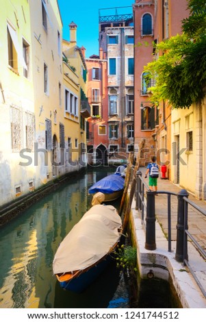 Venice colorful corners with canal, bridge, old buildings and architecture, boats and beautiful water reflections, Italy
