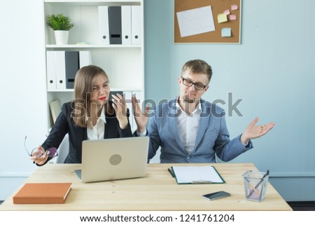 Business, teamwork and people concept - woman and man are working together in office. Bad emotions