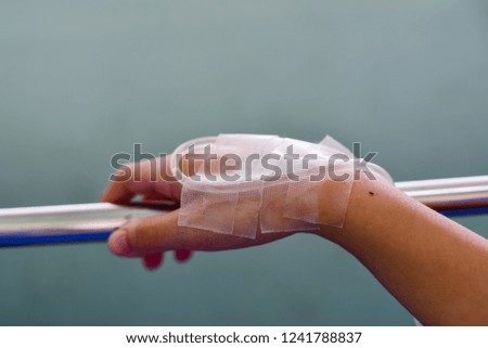 Intravenous line with adhesive plaster  in a patient's hand.