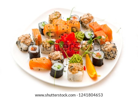 Assorted seafood rolls beautifully laid out on a platter on a white background.