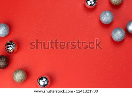 Gold and Silver Christmas ornament balls on red paper background
