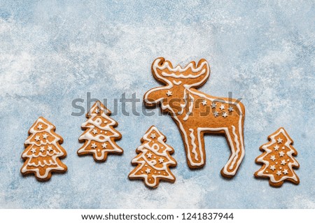 Christmas Gingerbread Cookies over Blue Concrete Background,  copy space for your text