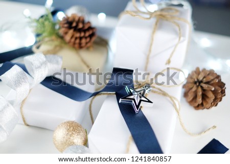 Minimal Christmas and New year flat lay gift box with pine tree and pine cone on white background