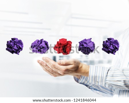 Hands of businessman holding crumpled paper on office interior background. Mixed media