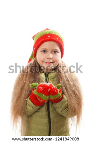 girl in Santa hat and mittens on the snowflakes on the palms