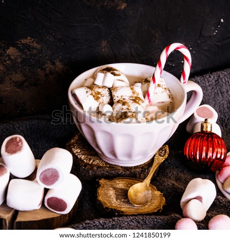Good New Year spirit. Coffee with marshmallows and cinnamon. Candy canes. Pink mug. Cooking yourself. Home comfort. New Year. Christmas time. Winter mood.