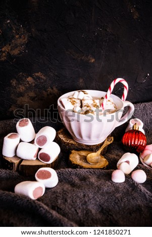 Good New Year spirit. Coffee with marshmallows and cinnamon. Candy canes. Pink mug. Cooking yourself. Home comfort. New Year. Christmas time. Winter mood.