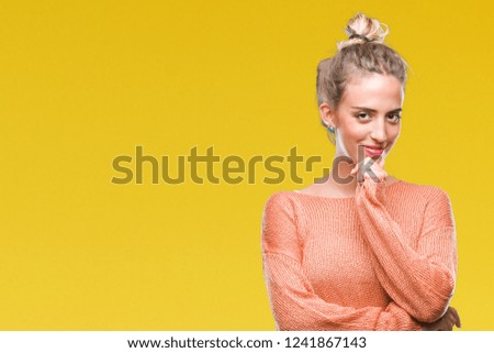 Beautiful young blonde woman over isolated background looking confident at the camera with smile with crossed arms and hand raised on chin. Thinking positive.