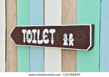 Toilet sign on colorful wall