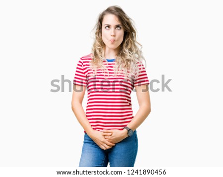 Beautiful young blonde woman over isolated background making fish face with lips, crazy and comical gesture. Funny expression.