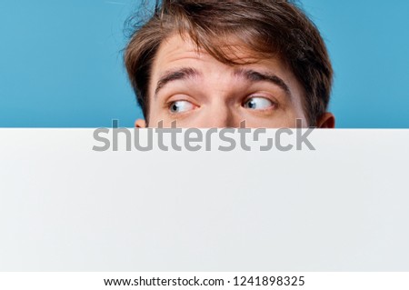 mockup poster man on a blue background looks away                           