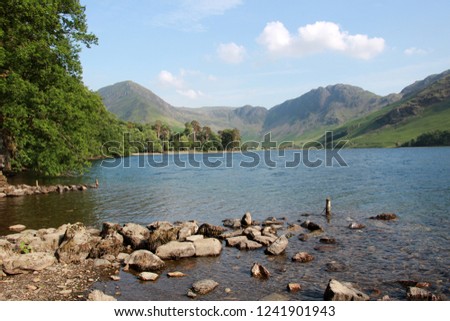 Buttermere lake with mountains in background in summer sunshine