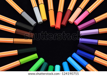 Color Pens in form of love on black background