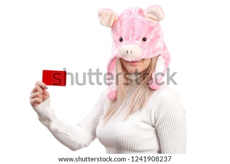 girl dressed in a pig costume, holding a business card in her hands, advertises