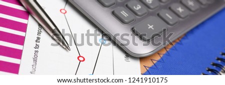 Silver pen and financial statistics on clipboard pad at office table closeup. Internal Revenue Service inspector sum check irs investigation earnings savings loan and credit concept