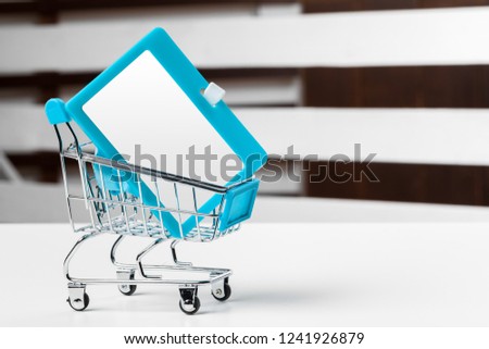 Selective focus of shopping cart or trolley with blank badge paper