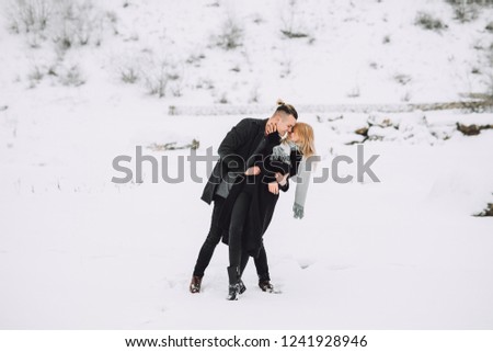 The beautiful and passion couple dressed in stylish winter clothes in the cold day.Winter Love Story.