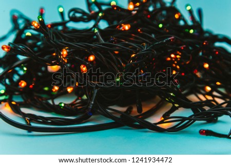 Christmas garland of lights and lanterns on a blue background