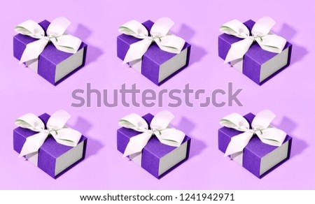 Pattern made of blue gift boxes on pastel background.