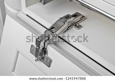 Metal hinges for a cupboard. Close Up. Royalty-Free Stock Photo #1241947888