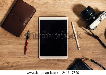 Top view of tablet computer ,notebook ,camera and accessories,Travel vacation background concept.