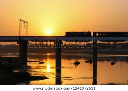 Morning hues with a Train journey, Shahibaugh Railway Bridge over Sabarmati River, Ahmedabad, India.