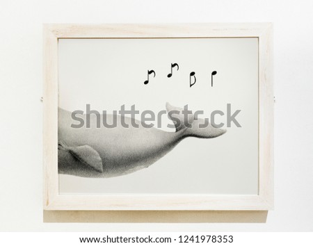 Framed art piece of a whale singing